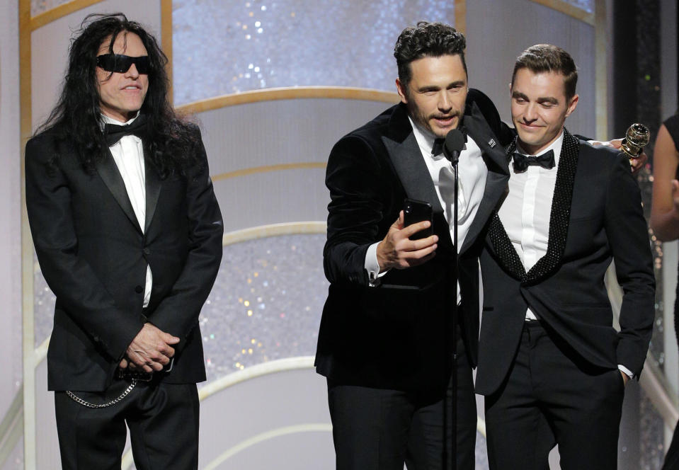 Jan 7, 2018; Beverly Hills, CA, USA; Tommy Wiseau (left) stands with James Franco of �The Disaster Artist as he accepts the award for Best Performance by an Actor in a Motion Picture �Musical or Comedy. Dave Franco stands at right during the 75th Golden Globe Awards at the Beverly Hilton. Mandatory Credit: Paul Drinkwater/NBC Handout via USA TODAY NETWORK/Sipa USA