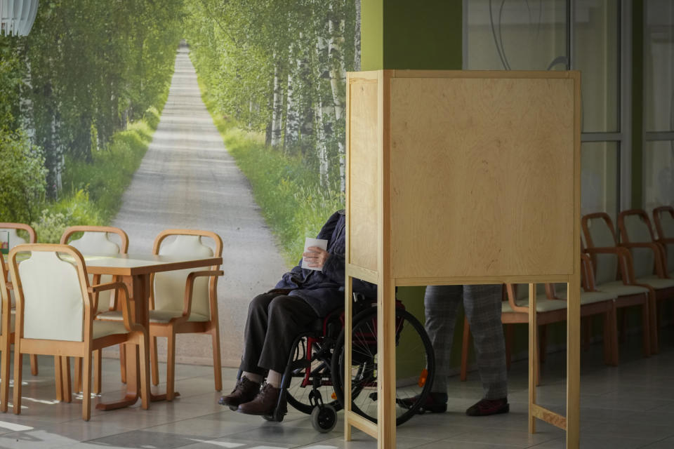 A voter leaves the cabin to cast a ballot at a polling station during parliamentary election in Turku, Finland, Sunday, April 2, 2023. (AP Photo/Sergei Grits)