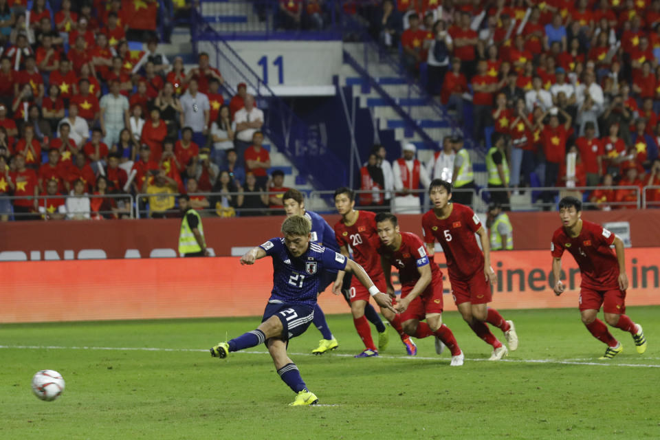 Japan's midfielder Ritsu Doan scores the penalty kick for the opening goal during the AFC Asian Cup quarterfinal soccer match between Japan and Vietnam at Al Maktoum Stadium in Dubai, United Arab Emirates, Thursday, Jan. 24, 2019. (AP Photo/Hassan Ammar)