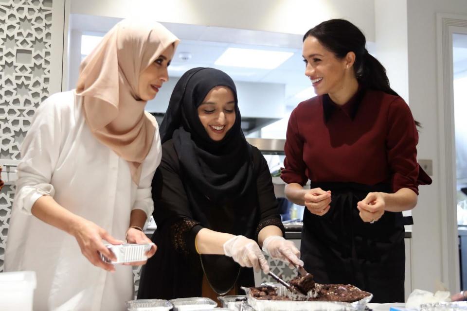 The Duchess of Sussex (right) during her to visit the Hubb Community Kitchen (PA)