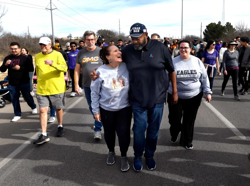 Janet Mendenhall laughs as she walks with Mayor Anthony Williams during Monday's Martin Luther King Jr. bridge march. This was Williams' final MLK march as Abilene's first Black mayor.