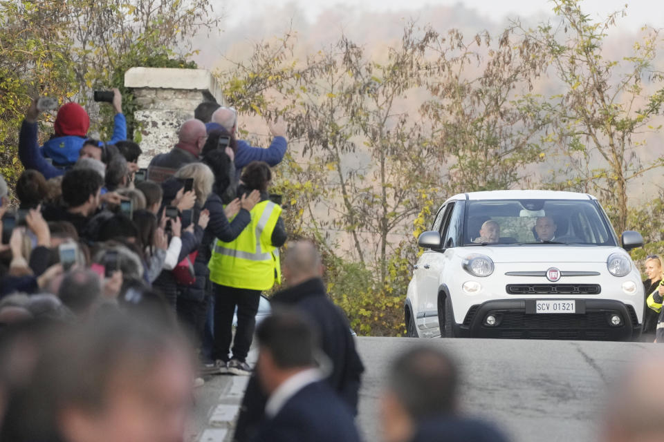 Pope Francis is cheered by faithful upon his arrival in San Carlo, near Asti, Italy, Saturday, Nov. 19, 2022. The Pontiff returned to his father's birthplace in northern Italy on Saturday for the first time since ascending the papacy to celebrate the 90th birthday of a second cousin who long knew him as simply "Giorgio." (AP Photo/Gregorio Borgia)