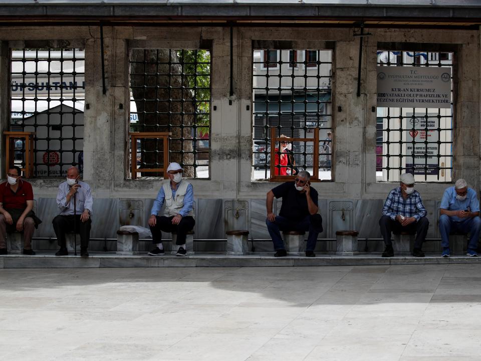 FILE PHOTO: Turkish citizen rest at the courtyard of Eyup Sultan Mosque after seniors over 65 years old, who are not allowed to go out of their houses, had been exempted from curfew for 6 hours amid the spread of the coronavirus disease (COVID-19), in Istanbul, Turkey, May 17, 2020. REUTERS/Umit Bektas