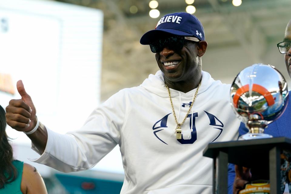 Jackson State head coach Deion Sanders poses with the trophy after the Orange Blossom Classic against Florida A&M.