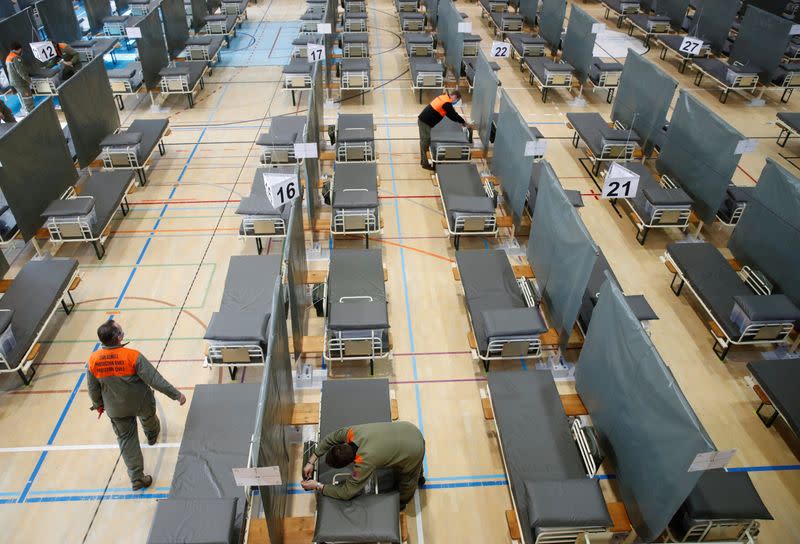 Civil defence workers prepare beds of the Medical Center Luzern which can offer some 220 additional beds for patients of the coronavirus disease (COVID-19) in Nottwil