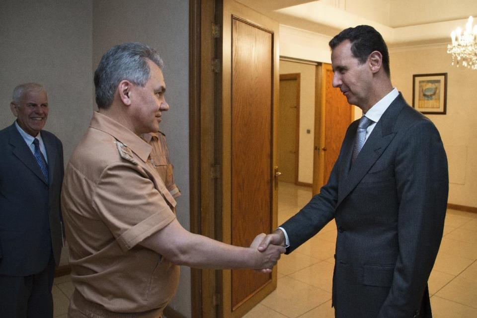 FILE -- In this June 18, 2016 file photo, Syrian President Bashar Assad, right, shakes hands with Russian Defense Minister Sergei Shoigu in Damascus, Syria. With his victory in Aleppo, Assad appears to have survived a nearly six-year war to drive him from power, but he is now more dependent on outside powers than ever. His key allies Russia and Iran, along with Turkey, are best placed to determine Syria’s endgame, which could more closely resemble a grand bargain among great powers than a political settlement among Syrians themselves. (Vadim Savitsky/ Russian Defense Ministry Press Service pool photo via AP, File)