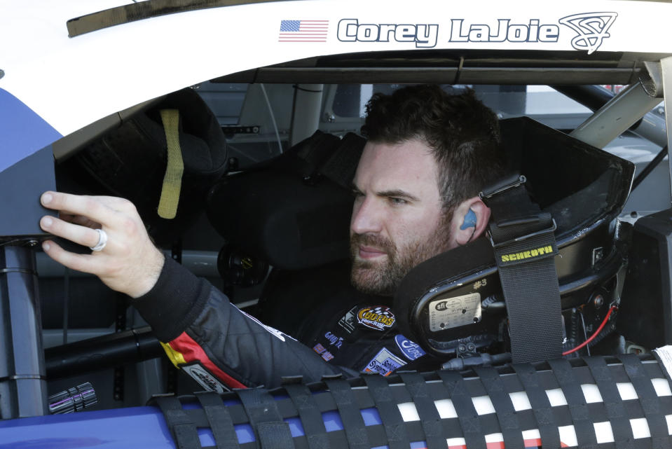 Corey LaJoie waits in his car during a NASCAR auto race practice at Daytona International Speedway, Saturday, Feb. 8, 2020, in Daytona Beach, Fla. (AP Photo/Terry Renna)