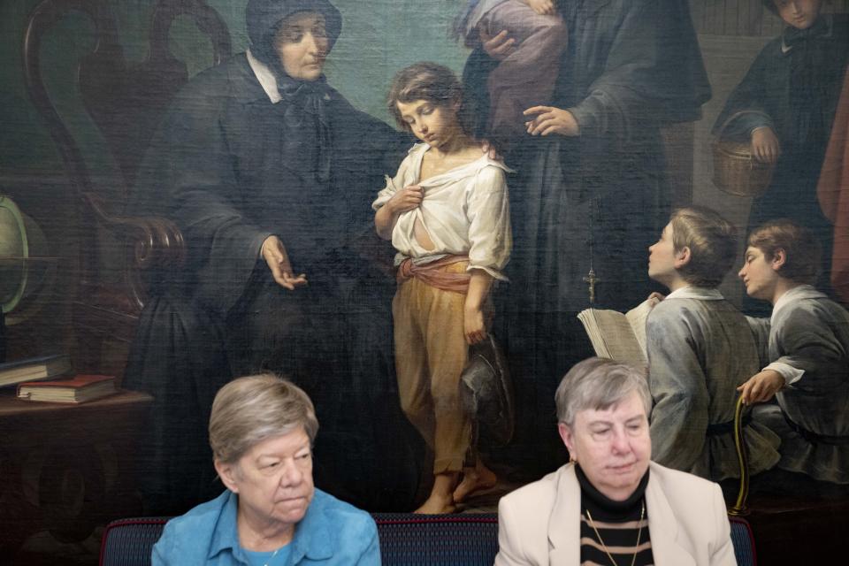 Sisters Donna Dodge, left, and Margaret M. O'Brien, right, members of the leadership council of the Sisters of Charity, are interviewed as a group with their colleagues beside The Sister of Charity, a painting by an M. Galliardi circa 1873, at the College of Mount Saint Vincent, a private Catholic college in the Bronx borough of New York, on Tuesday, May 2, 2023. In more than 200 years of service, the Sisters of Charity of New York have cared for orphans, taught children, nursed the Civil War wounded and joined Civil Rights demonstrations. Last week, the Catholic nuns decided that it will no longer accept new members in the United States and will accept the "path of completion." (AP Photo/John Minchillo)