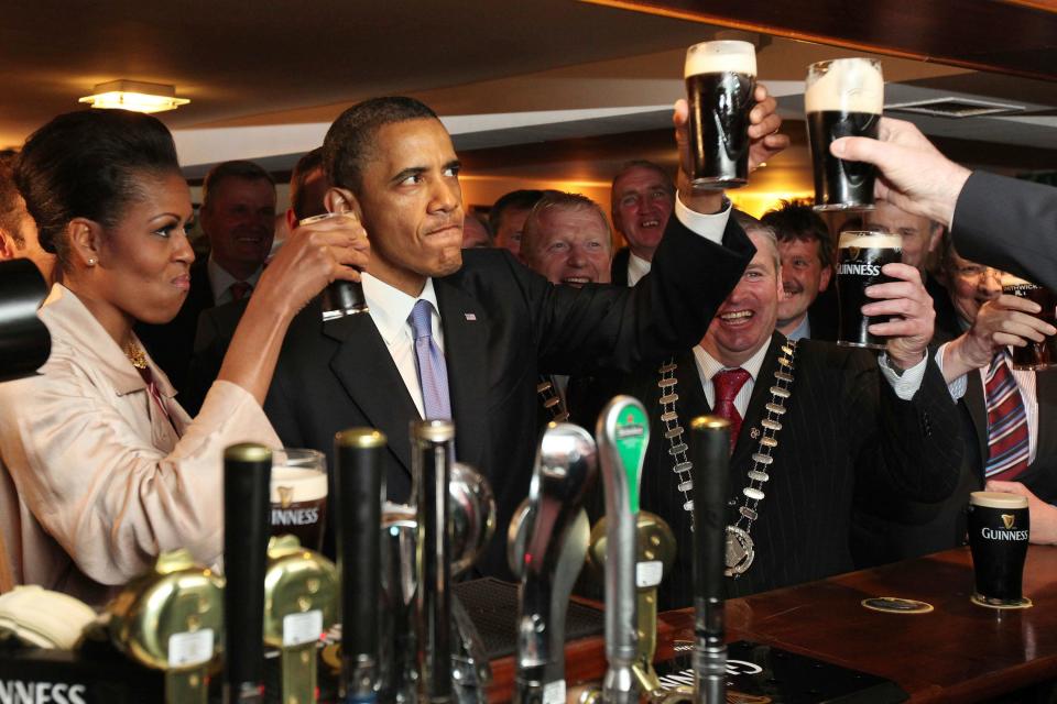 President Barack Obama and first lady Michelle Obama drink Guinness beer as they meet with local residents at Ollie Hayes pub in Moneygall, Ireland, the ancestral homeland of his great-great-great grandfather.