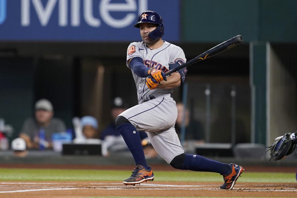 Houston Astros' Jose Altuve follows through on a double to left field in the first inning of a baseball game against the Texas Rangers, Monday, June 13, 2022, in Arlington, Texas. (AP Photo/Tony Gutierrez)