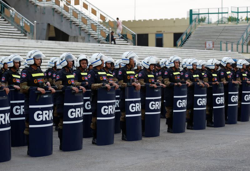 Police officers stand guard near the Municipal Court of Phnom Penh