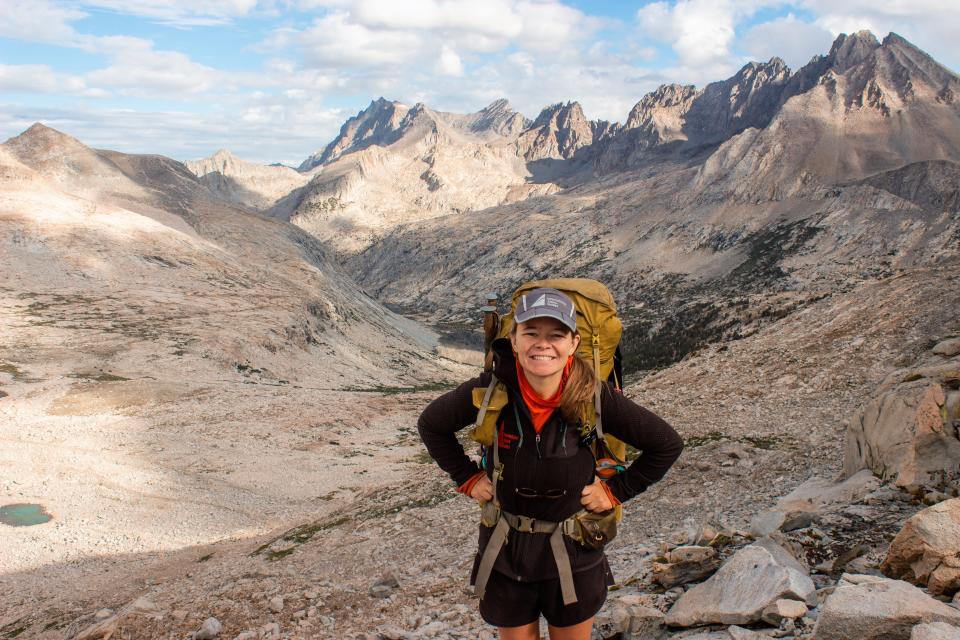 nicole jordan hiking in national park with mountains in the background