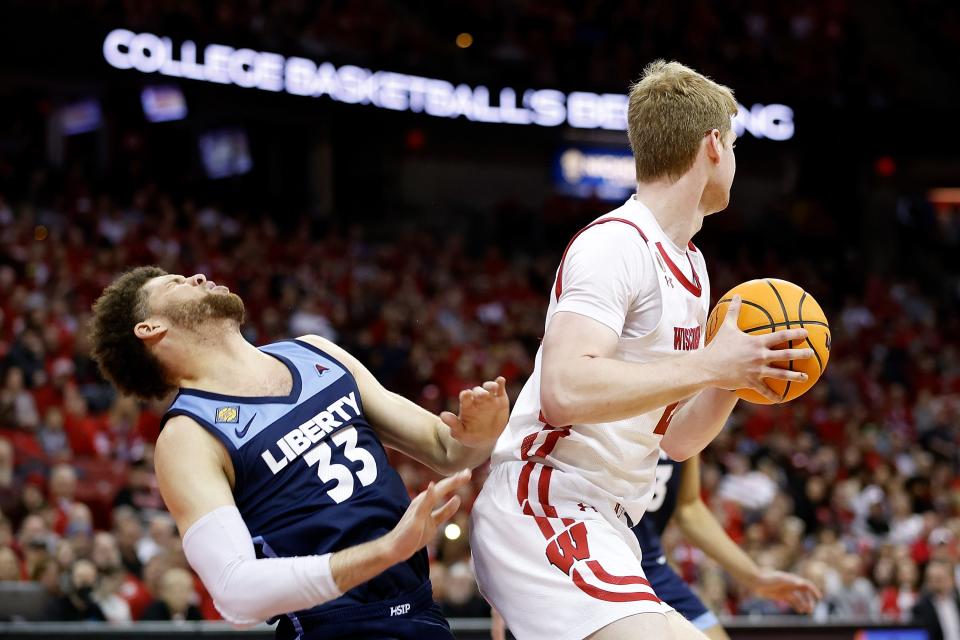 Wisconsin's Steven Crowl and Liberty's Shiloh Robinson collide during the second half of their game Sunday. Coach Greg Gard said he likes that Crowl is playing more "aggressive" lately.