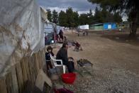 A Syrian refugee man prepares chicken on a grill outside his shelter at the refugee camp of Ritsona about 86 kilometers (53 miles) north of Athens, Thursday, Jan. 5, 2017. Over 62,000 refugees and migrants are stranded in Greece after a series of Balkan border closures and an European Union deal with Turkey to stop migrant flows. (AP Photo/Muhammed Muheisen)