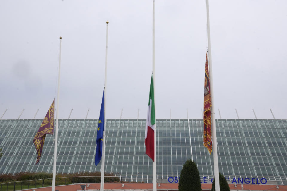 Flags at half mast are seen outside the Dell'Angelo hospital where the bus injured passengers are hospitalised after an accident in Mestre, near the city of Venice, Italy, Wednesday, Oct. 4, 2023. The bus fell from an elevated road, late Tuesday, killing multiple people. (AP Photo/Antonio Calanni)