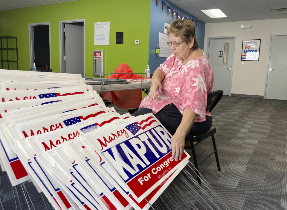 Carol Discher, a volunteer for the reelection campaign for Rep. Marcy Kaptur, D-Ohio, stacks yard signs in Toledo, Ohio, on Saturday, Sept. 17, 2022. Kaptur appeared with President Joe Biden during his July visit to Ohio but has since produced an ad saying she “doesn’t work for Joe Biden,” evidence of how some Democrats are struggling with how much to embrace -- or distance themselves -- from the president ahead of November’s midterm elections. (AP Photo/Will Weissert)