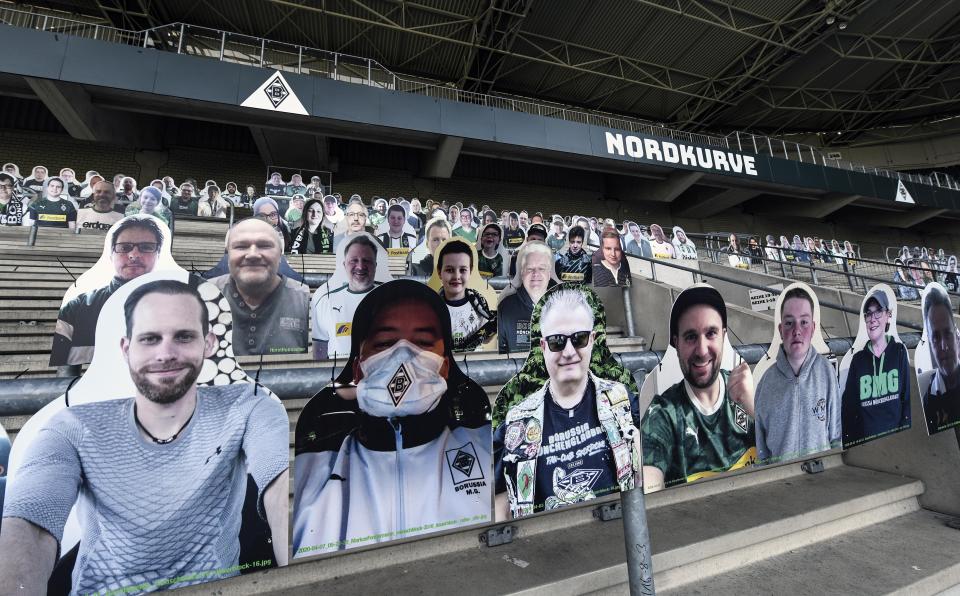 In this Thursday, April 16, 2020 file photo, portraits are set on the supporters tribune of German Bundesliga soccer club Borussia Moenchengladbach at the stadium in Moenchengladbach, Germany.  All major events in Germany are suspended due to the coronavirus outbreak and the Bundesliga's plans to re-start in May are meeting increased opposition with a German virologist, warning that players' safety is at stake. (AP Photo/Martin Meissner)