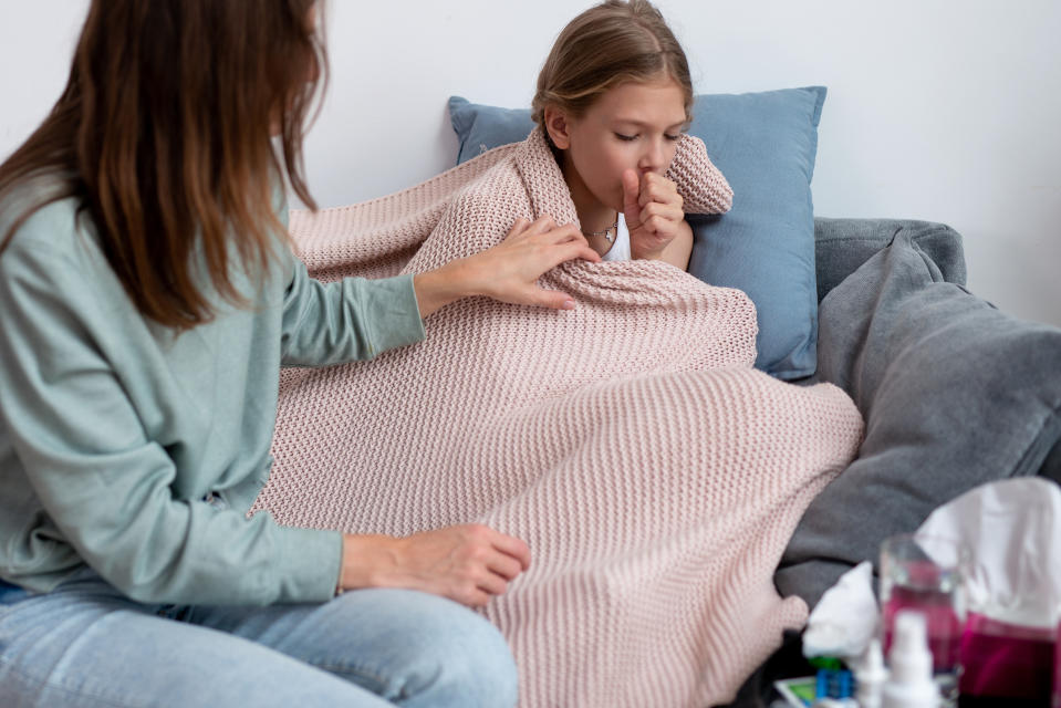 Newfoundland and Labrador's health officials are warning of a whooping cough outbreak in the province. They're urging residents to make sure their vaccines are up to date. (Image via Getty) Girl Is Sick and Coughing Her Mom Sits Next To Her.