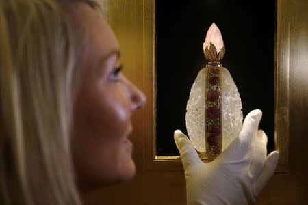 An employee poses with "L'Oeuf" by Henry Jacques, the last of a limited edition of nine, on sale at 182,000 pounds ($286,049) at the Salon de Parfums in Harrods, London, December 9, 2014. REUTERS/Luke MacGregor