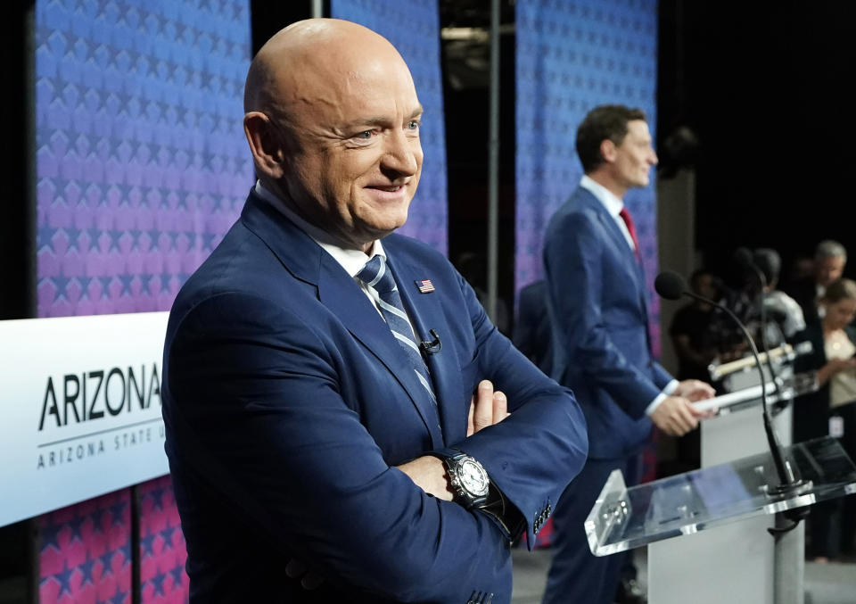 FILE - Arizona Democratic Sen. Mark Kelly, left, smiles as he stands on stage with Republican challenger Blake Masters, right, prior to a televised debate in Phoenix on Oct. 6, 2022. Arizona Sen. Mark Kelly on Tuesday, Oct. 25, 2022, urged the federal government to withhold money for environmental cleanup at the Salton Sea until California agrees to give up more of its river water. (AP Photo/Ross D. Franklin, File)