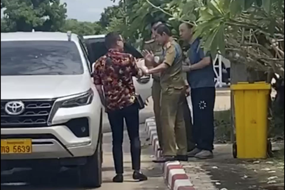FILE -In this UGC image made from video by a source wishing to remain anonymous, one of the two activists, left, traveling with Chinese rights lawyer Lu Siwei, right, argues with police who were in the process of detaining Lu, near the Thanaleng dry port, 13 kilometers (8 miles), south of Vientiane, on July 28, 2023. The Chinese rights lawyer arrested in the Southeast Asian country of Laos has been deported back to China, his attorney said, despite pleas from rights groups and U.N. experts for his release. (Anonymous Source via AP, File)