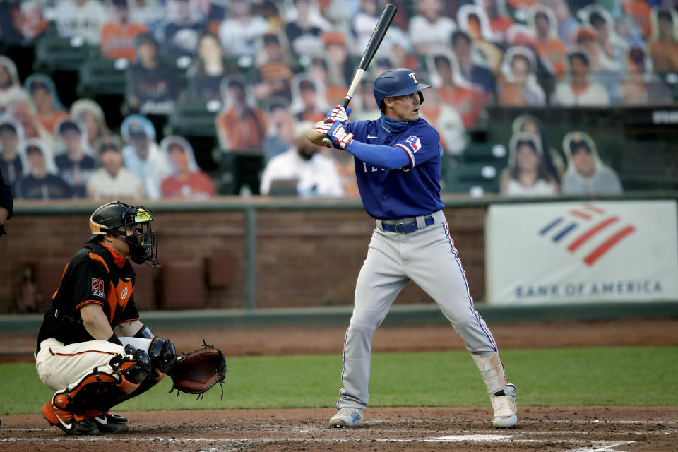 Texas Rangers' Scott Heineman, right, waits for the pitch as his brother, San Francisco Giants catcher Tyler Heineman, left, gives a signal during the second inning of a baseball game Saturday, Aug. 1, 2020, in San Francisco. (AP Photo/Ben Margot)