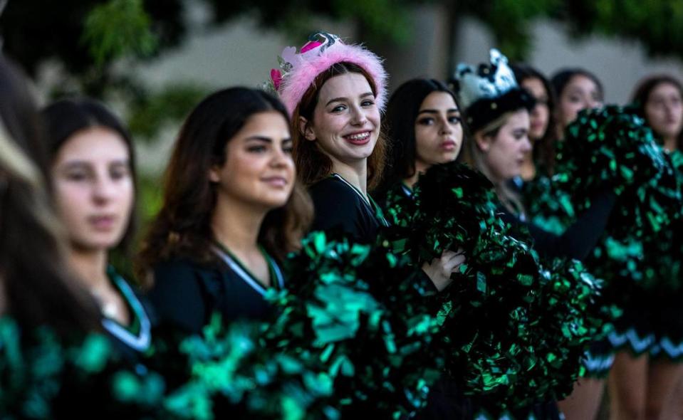 Senior Aileen Gonzalez, wearing a pink crown, cheers with other cheerleaders as students arrive at Hialeah Gardens Senior High School for the first day of school.