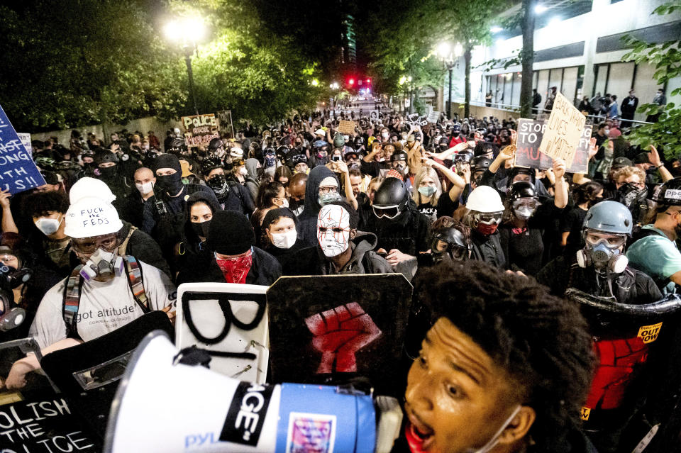 Black Lives Matter protesters march through Portland, Ore. after rallying at the Mark O. Hatfield United States Courthouse on Sunday, Aug. 2, 2020. Following an agreement between Democratic Gov. Kate Brown and the Trump administration to reduce federal officers in the city, nightly protests remained largely peaceful without major confrontations between demonstrators and officers. (AP Photo/Noah Berger)