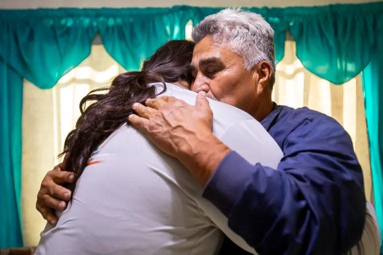 Guillermo Garcia holds his granddaughter, Karina, in a close embrace in Juárez on Nov. 20.