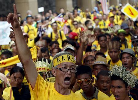 A supporter of pro-democracy group "Bersih" (Clean) leads a group of native people known as "orang asli", as they march to Dataran Merdeka in Malaysia's capital city of Kuala Lumpur August 30, 2015. REUTERS/Edgar Su