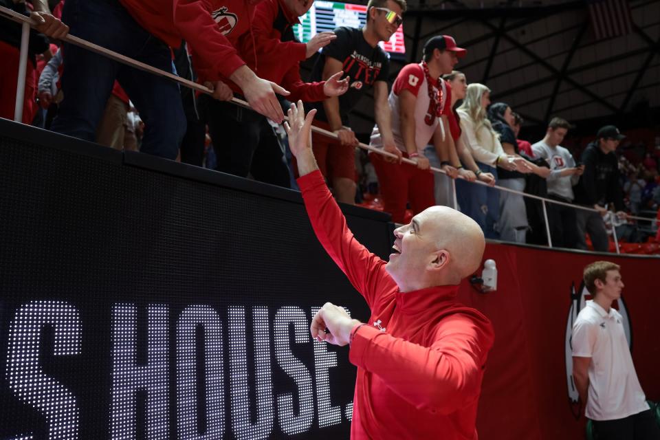 Utah coach Craig Smith celebrates with fans after the Runnin’ Utes beat Utah Valley at the Huntsman Center in Salt Lake City on Saturday, Dec. 16, 2023. | Spenser Heaps, Deseret News