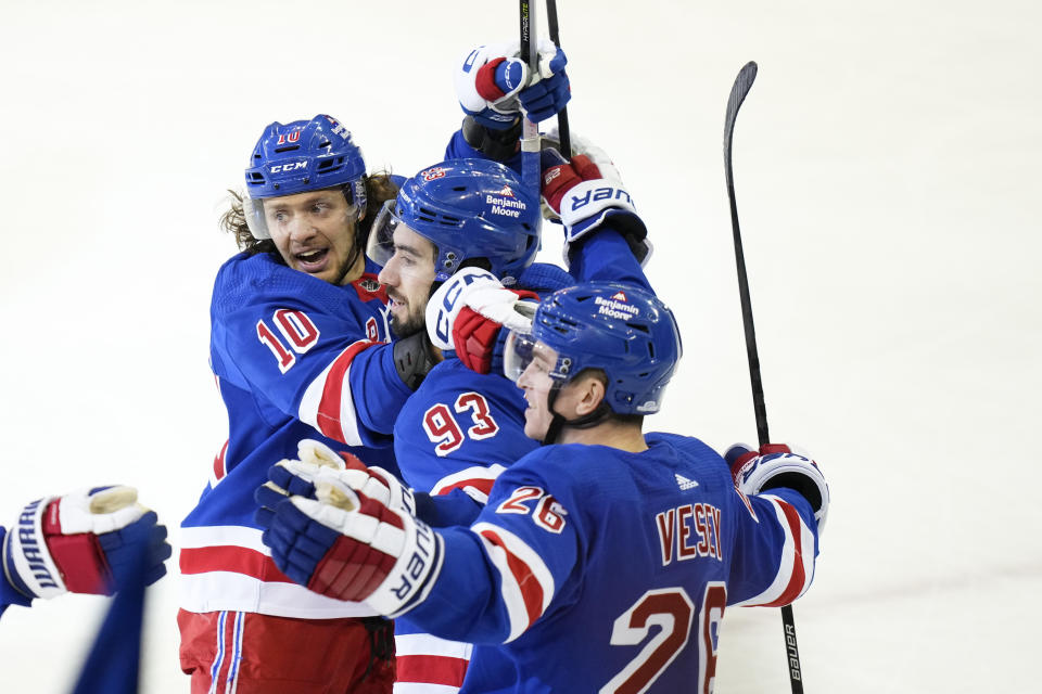 New York Rangers' Mika Zibanejad (93) celebrates with teammate Artemi Panarin (10) and Jimmy Vesey (26) after scoring a goal during the third period of an NHL hockey game against the Vancouver Canucks Wednesday, Feb. 8, 2023, in New York. The Rangers won 4-3. (AP Photo/Frank Franklin II)