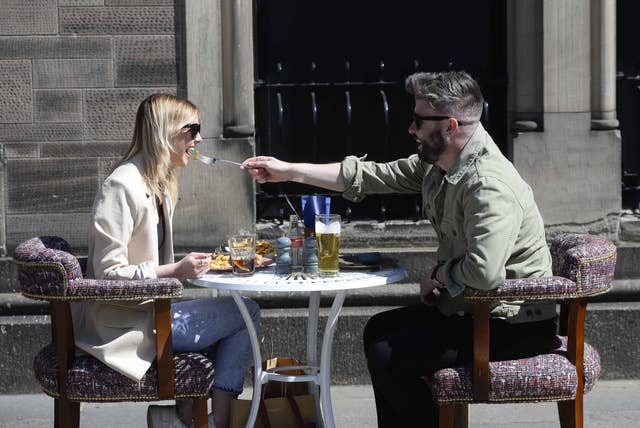 Members of the public enjoy a drink and a meal in Belfast 