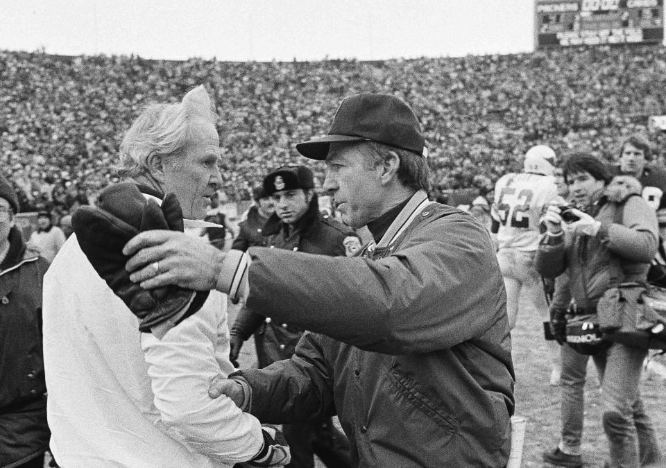 FILE - In this Jan. 8, 1983, file photo, St. Louis Cardinals coach Jim Hanifan, left, and Green Bay Packers coach Bart Starr meet after the Packers' 41-16 victory in an NFL football playoff game in Green Bay, Wis. Hanifan, the former Cardinals coach who returned to the city as offensive line coach to help the Rams win the Super Bowl, has died. He was 87. Hanifan’s daughter, Kathy Hinder, told the St. Louis Post-Dispatch that he died Tuesday, Nov. 23, 2020. She said the cause of death hasn't been determined, but said it wasn't related to COVID-19. (AP Photo/Tom Lynn, File)