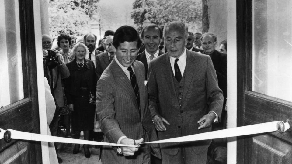 two men cutting a ribbon at opening event 