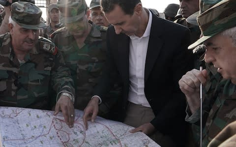 Syrian President Bashar al-Assad (C-R) meeting with Syrian army personnel on frontlines of al-Habit town in Idlib countryside, Syria - Credit: Sana