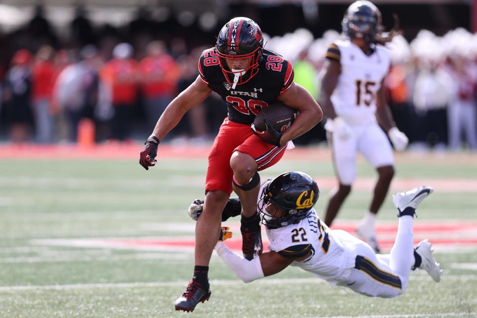 Utah's Sione Vaki runs the ball against California defensive back Matthew Littlejohn in the second quarter at Rice-Eccles Stadium, Oct. 14, 2023 in Salt Lake City, Utah.