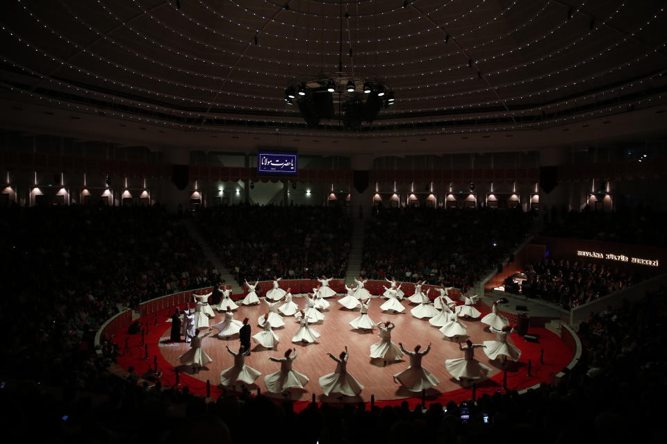 In this photo taken on Sunday, Dec. 16, 2018, whirling dervishes of the Mevlevi order perform at the start of a Sheb-i Arus ceremony in Konya, central Turkey. Every December the Anatolian city hosts a series of events to commemorate the death of 13th century Islamic scholar, poet and Sufi mystic Jalaladdin Rumi. (AP Photo/Lefteris Pitarakis)
