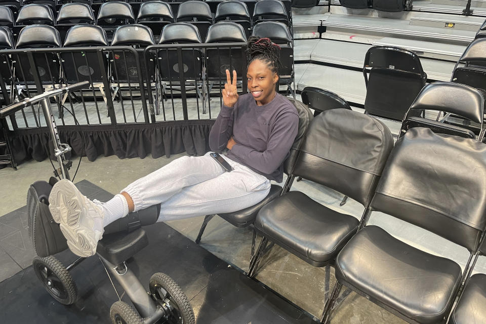 Las Vegas Aces point guard Chelsea Gray wears a boot during a team availability at Barclays Center in New York on Oct. 17, 2023. Gray is out at least for Game 4 of the WNBA Finals against the New York Liberty after suffering an injury to her left foot Sunday. (AP Photo/Doug Feinberg)