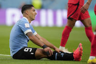Uruguay's Luis Suarez sits on the grass during the World Cup group H soccer match between Uruguay and South Korea, at the Education City Stadium in Al Rayyan , Qatar, Thursday, Nov. 24, 2022. (AP Photo/Martin Meissner)