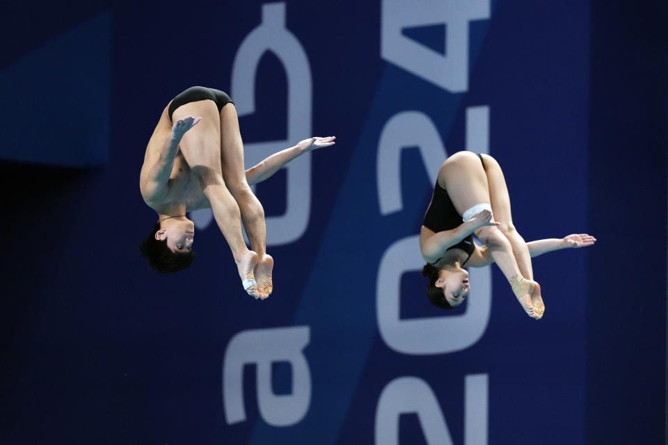 Yi Jaegyeong and Kim Suji of South Korea compete during the mixed 3m synchronised diving final at the World Aquatics Championships in Doha, Qatar, Saturday, Feb. 10, 2024. (AP Photo/Hassan Ammar)