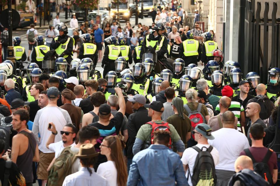 Police presence among demonstrators during an anti-vax protest (PA)