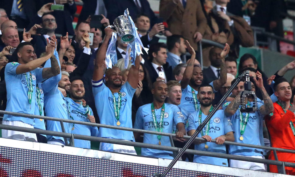 Manchester City players celebrate with the EFL Cup trophy on Sunday at Wembley. (Getty)