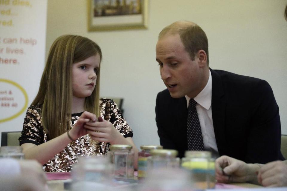 Britain's Prince William speaks with Aoife, 9, during his visit to a Child Bereavement UK Centre in Stratford in east London, Wednesday, Jan. 11, 2017. Prince William has been the royal patron of the Child Bereavement UK organisation since 2009. It supports families and educates professionals when a baby or child of any age dies or is dying, or when a child is facing bereavement. (AP Photo/Matt Dunham, Pool)