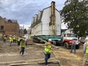 Workers prepare to move the original structure that held what is believed to be the oldest schoolhouse in the U.S. for Black children in Williamsburg, Virginia, on Friday, Feb. 10, 2023. (AP Photo/ Ben Finley)