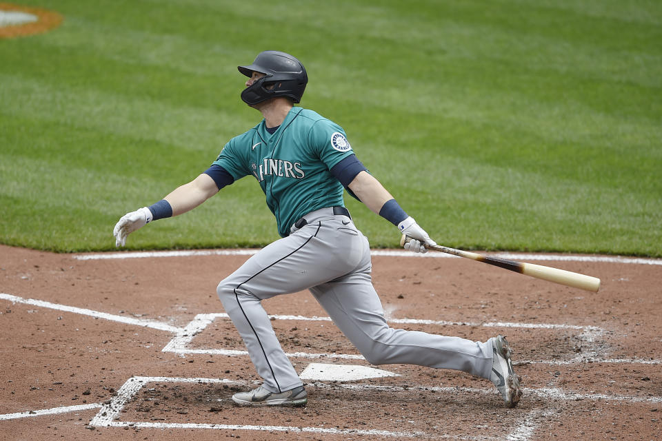 Seattle Mariners' Mitch Haniger follows through on a two run home run against the Baltimore Orioles in the fifth inning of the first game of a baseball doubleheader, Thursday, April 15, 2021, in Baltimore. (AP Photo/Gail Burton)