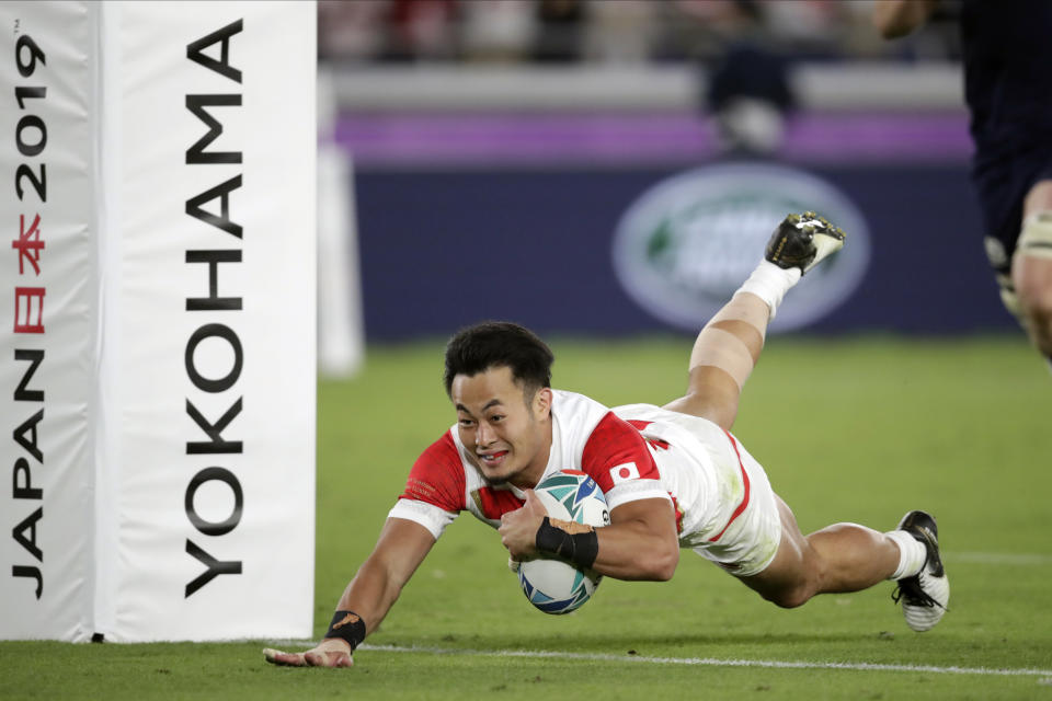 Japan's Kenki Fukuoka scores a try during the Rugby World Cup Pool A game at International Stadium against Scotland in Yokohama, Japan, Sunday, Oct. 13, 2019. (AP Photo/Jae Hong)