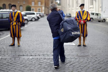 Roberto, an homeless that lives around Vatican, walks to Swiss guards before to enter the Vatican March 26, 2015. REUTERS/Max Rossi