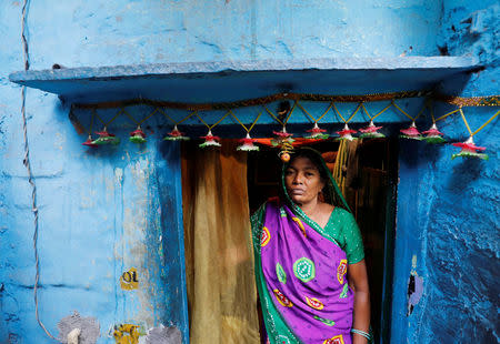Sushila Devi, whose husband and son died after a brawl with neighbours over water in March, stands outside her house in New Delhi, India, June 27, 2018. REUTERS/Adnan Abidi