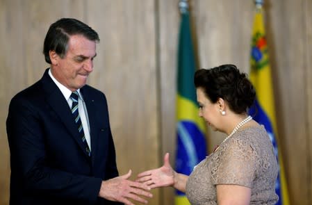 Brazil's President Jair Bolsonaro shakes hands with Venezuela's ambassador to Brazil Maria Teresa Belandria during the credentials presentation ceremony of several new diplomats, in Brasilia